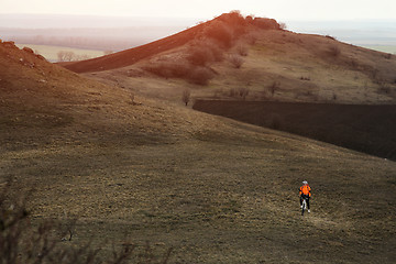 Image showing Man cyclist with backpack riding the bicycle