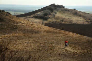 Image showing Man cyclist with backpack riding the bicycle