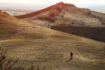 Image showing Man cyclist with backpack riding the bicycle