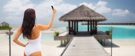 Image showing young woman taking selfie with smartphone