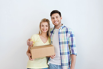 Image showing smiling couple with box moving to new home