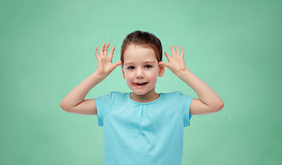 Image showing happy little girl having fun and making ears