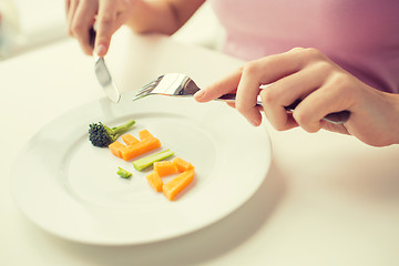 Image showing close up of woman hands eating vegetables