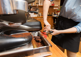 Image showing close up of woman making coffee by machine at cafe