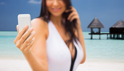 Image showing young woman taking selfie with smartphone