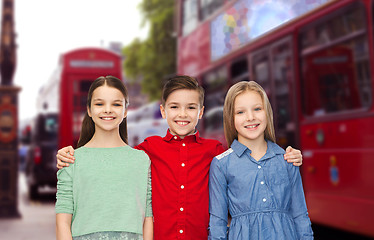 Image showing happy boy and girls hugging over london city