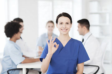 Image showing happy doctor over group of medics at hospital