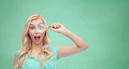 Image showing happy young woman with magnifying glass