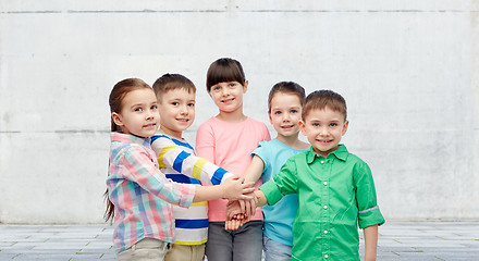 Image showing happy little children holding hands on street