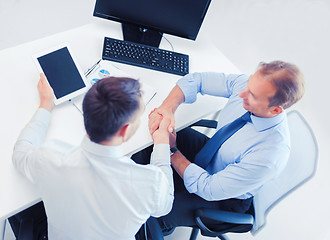 Image showing businessmen shaking hands in office