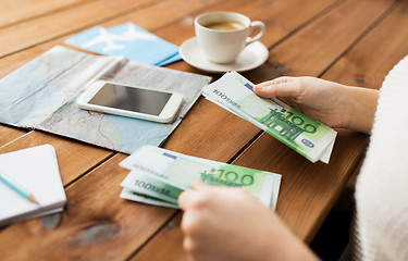 Image showing close up of traveler hands counting euro money