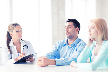 Image showing doctor with patients in cabinet