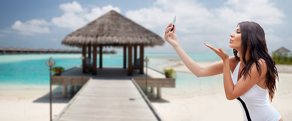 Image showing young woman taking selfie with smartphone