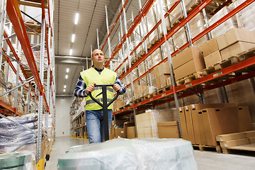 Image showing man carrying loader with goods at warehouse