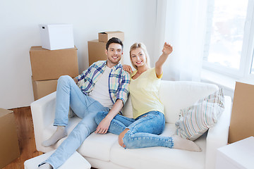 Image showing couple with boxes moving to new home and dreaming