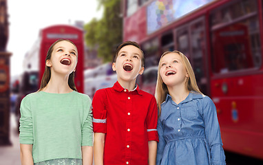 Image showing amazed boy and girls looking up over london city