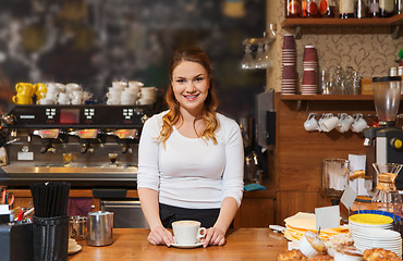 Image showing happy barista woman with latte at coffee shop