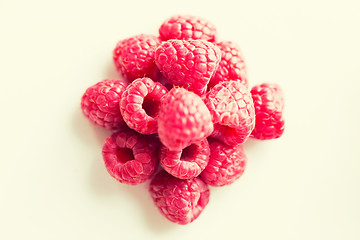 Image showing juicy fresh ripe red raspberries on white