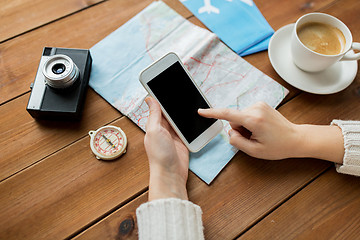 Image showing close up of traveler hands with smartphone and map