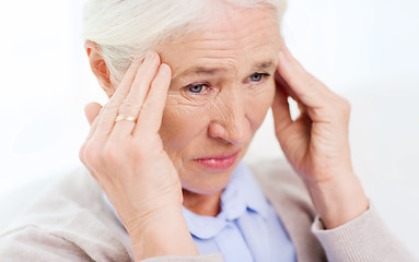 Image showing face of senior woman suffering from headache