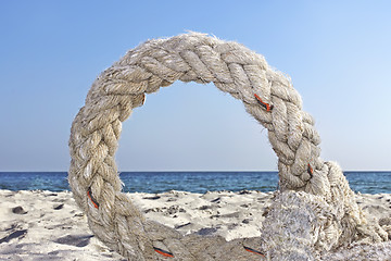 Image showing Ring of old rope on a seashore