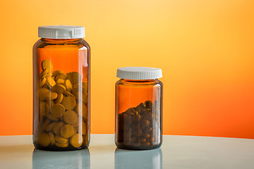 Image showing Two glasses with pills on a table