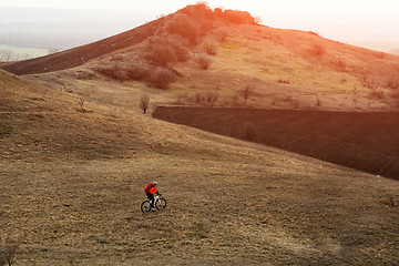 Image showing Man cyclist with backpack riding the bicycle