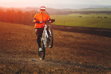 Image showing Man cyclist with backpack riding the bicycle