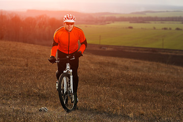 Image showing Man cyclist with backpack riding the bicycle