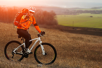 Image showing Man cyclist with backpack riding the bicycle