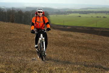 Image showing Man cyclist with backpack riding the bicycle