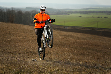 Image showing Man cyclist with backpack riding the bicycle