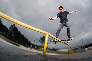 Image showing Skateboarder doing a board slide