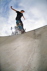 Image showing Skateboarder doing a tail slide