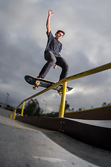 Image showing Skateboarder doing a board slide