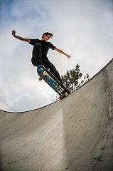 Image showing Skateboarder doing a tail slide