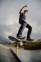 Image showing Skateboarder doing a board slide