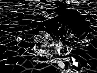 Image showing Destructed and splitted glass pieces on black