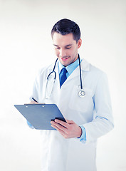Image showing male doctor writing prescription