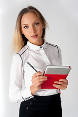 Image showing Pretty businesswoman standing with organizer diary