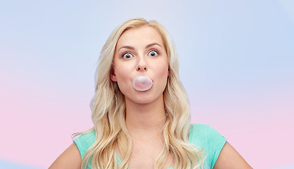 Image showing happy young woman or teenage girl chewing gum