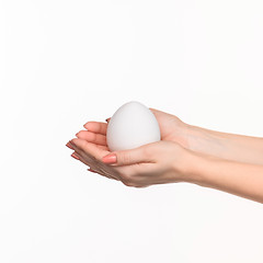 Image showing Hands holding a egg on white background