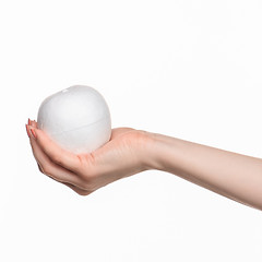 Image showing Hand holding a egg on white background