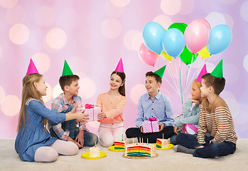 Image showing happy children giving presents at birthday party