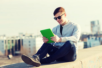 Image showing happy young man with tablet pc outdoors