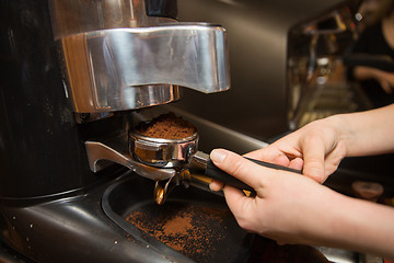 Image showing close up of woman making coffee by machine at cafe