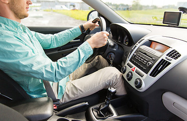 Image showing close up of young man driving car