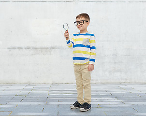 Image showing little boy in eyeglasses with magnifying glass