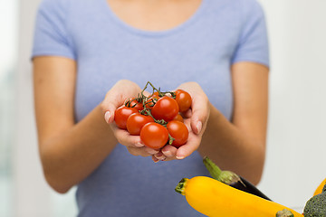 Image showing close up of woman holding cherry tomatoes in hands