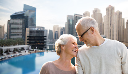 Image showing senior couple hugging over dubai city waterfront